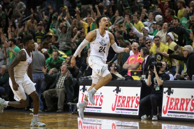 Oregon's Dillon Brooks, center, leaps in the air in celebration after sinking the game winning shot over UCLA in an NCAA college basketball game Wednesday, Dec. 28, 2016, in Eugene, Ore. (AP Photo/Chris Pietsch)